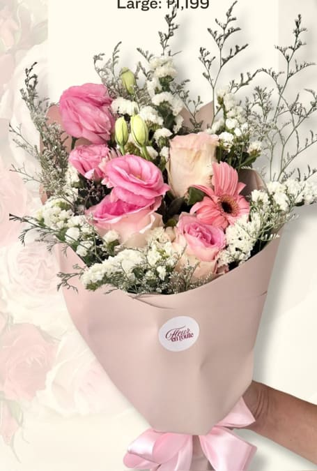 Loose pink and white bouquet with lisianthus, roses, and misty fillers in taupe wrap
